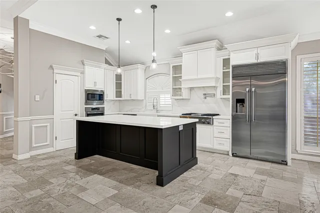 a kitchen with stainless steel appliances granite countertop a refrigerator and a sink