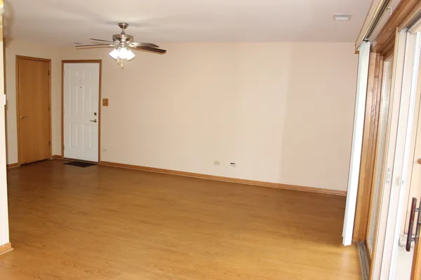 a view of a room with wooden floor and windows