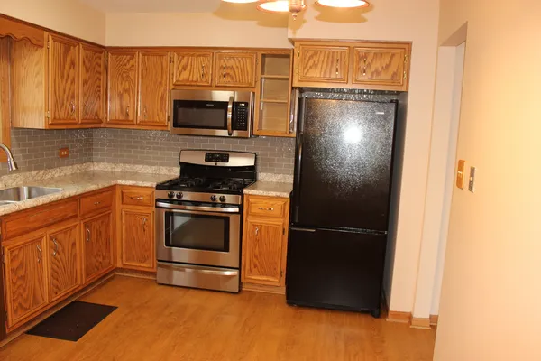 a kitchen with stainless steel appliances a sink a stove and a microwave