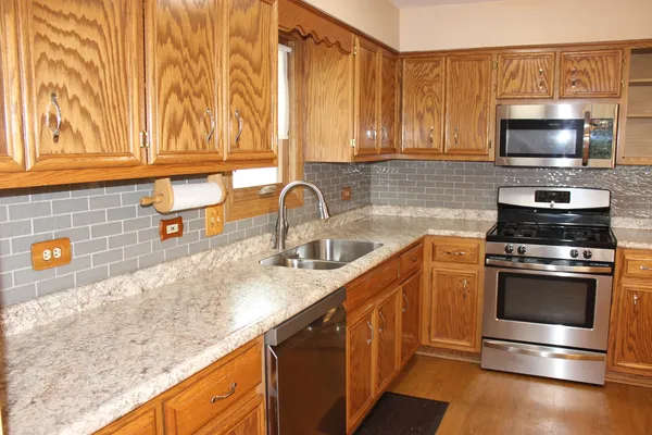 a kitchen with stainless steel appliances a stove and a refrigerator