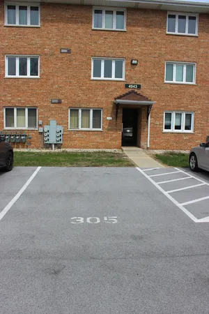 a front view of a building with trees