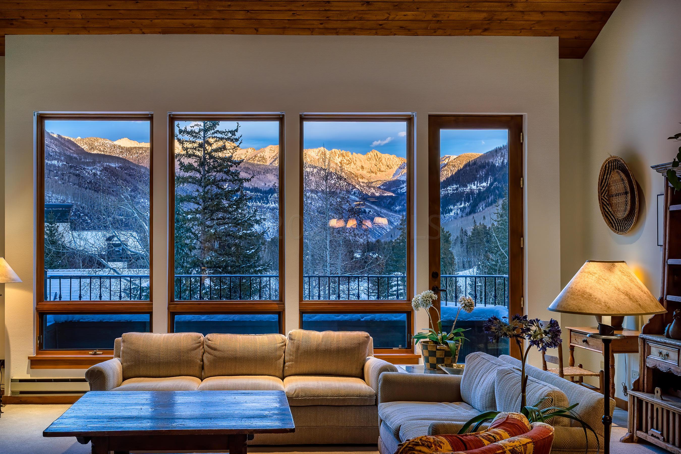 600 Vail Valley Drive, Unit E 9 Vail, CO 81657 - Photo 2 of 26 a living room with furniture and a lamp