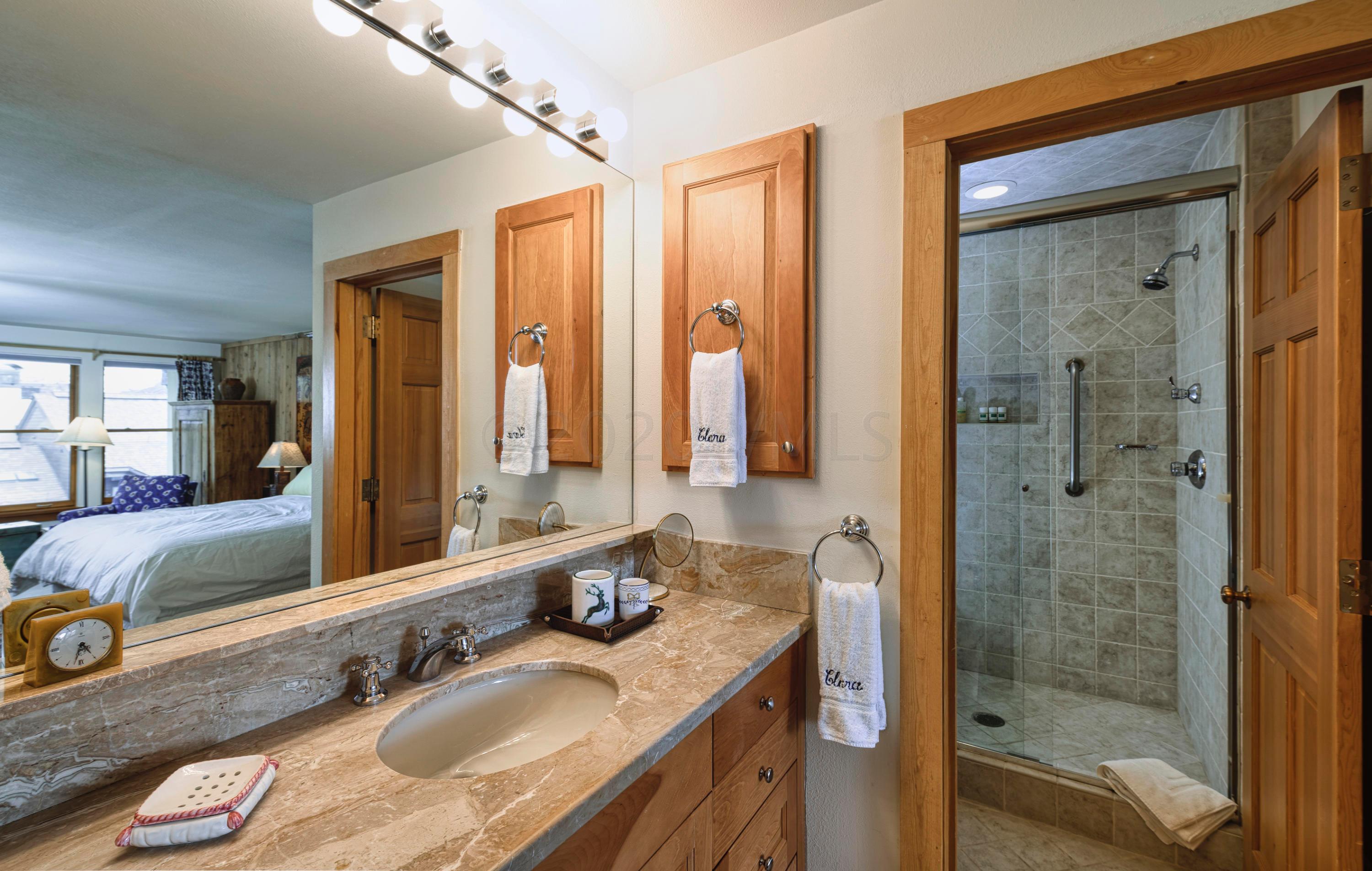 600 Vail Valley Drive, Unit E 9 Vail, CO 81657 - Photo 9 of 26 a bathroom with a granite countertop sink mirror and double