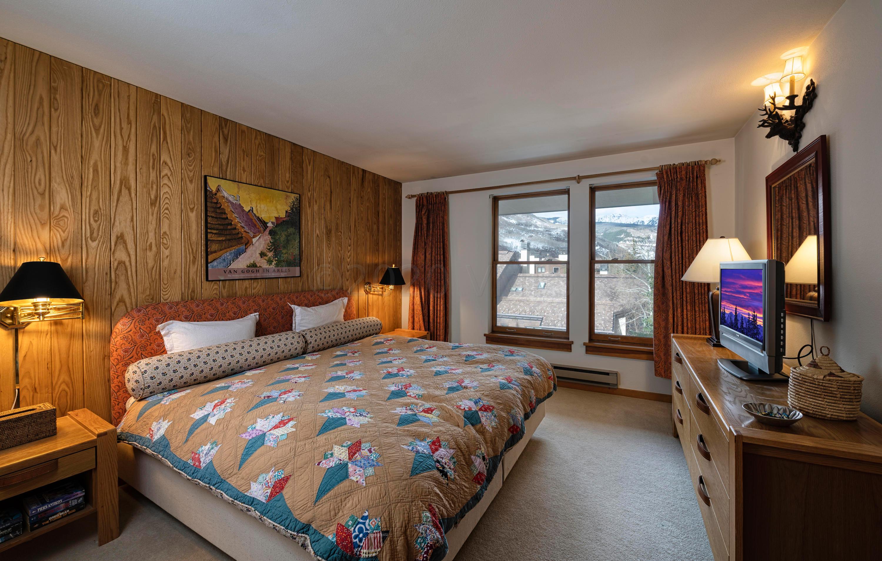 600 Vail Valley Drive, Unit E 9 Vail, CO 81657 - Photo 10 of 26 a bedroom with beds and a flat screen tv