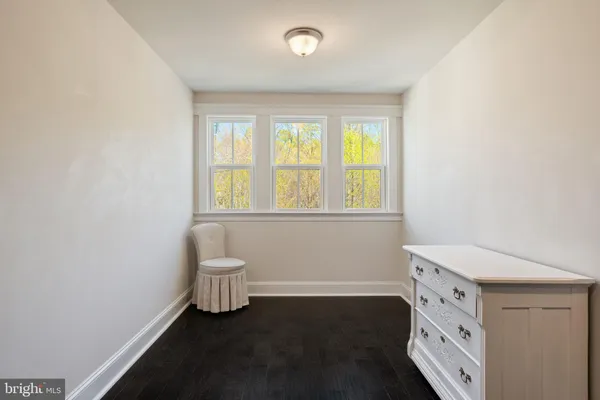 a dining room with furniture a chandelier and wooden floor