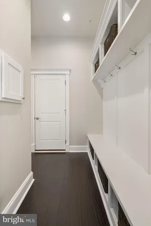 a living room with furniture kitchen view and a wooden floor