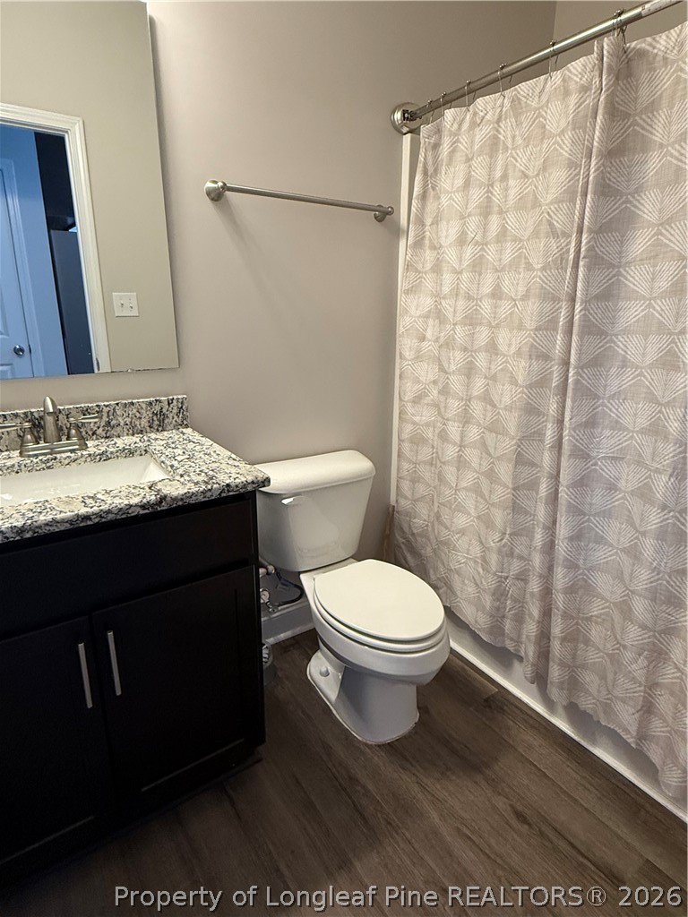 663 Hector McNeill Road Raeford, NC 28376 - Photo 13 of 16 a bathroom with a granite countertop sink toilet and shower
