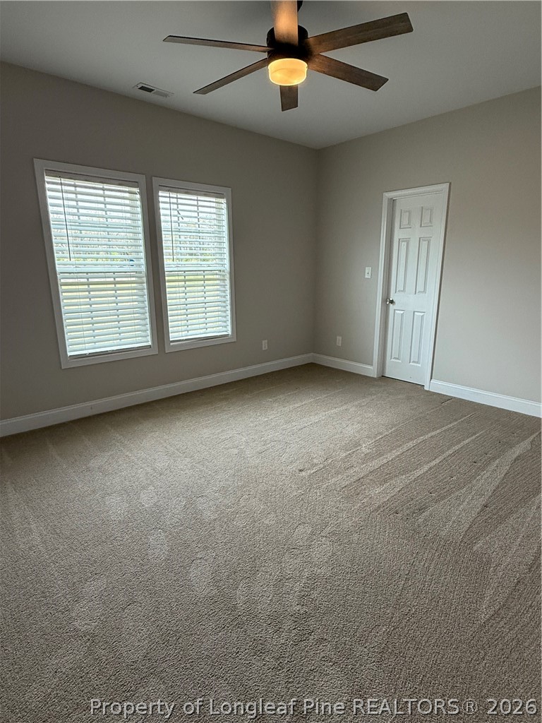 663 Hector McNeill Road Raeford, NC 28376 - Photo 15 of 16 en empty room with windows and ceiling fan