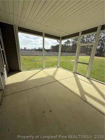 view of an empty room with a balcony