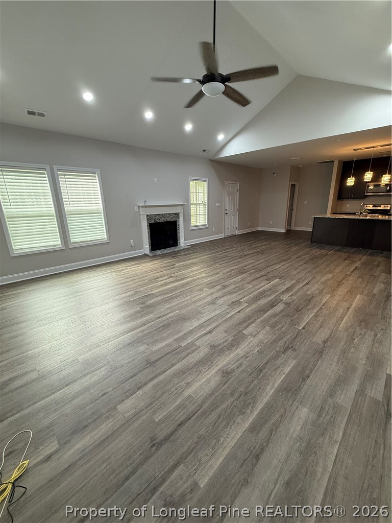 663 Hector McNeill Road Raeford, NC 28376 - Photo 5 of 16 a view of an empty room with window and wooden floor