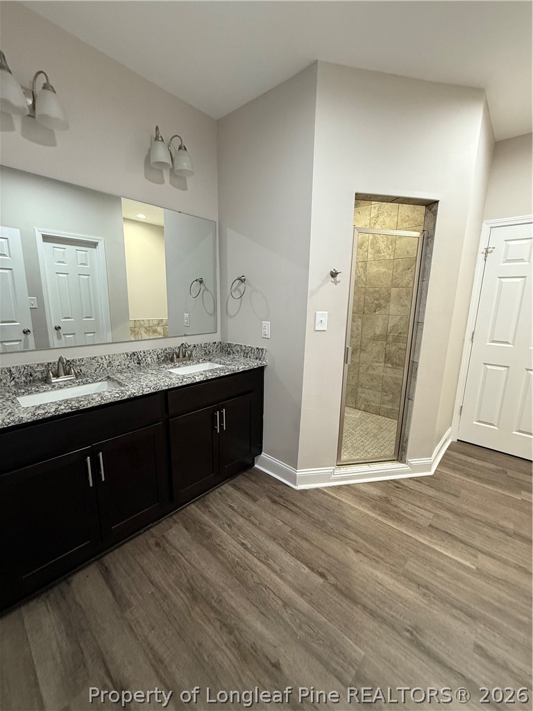 663 Hector McNeill Road Raeford, NC 28376 - Photo 8 of 16 a spacious bathroom with a granite countertop sink and a mirror