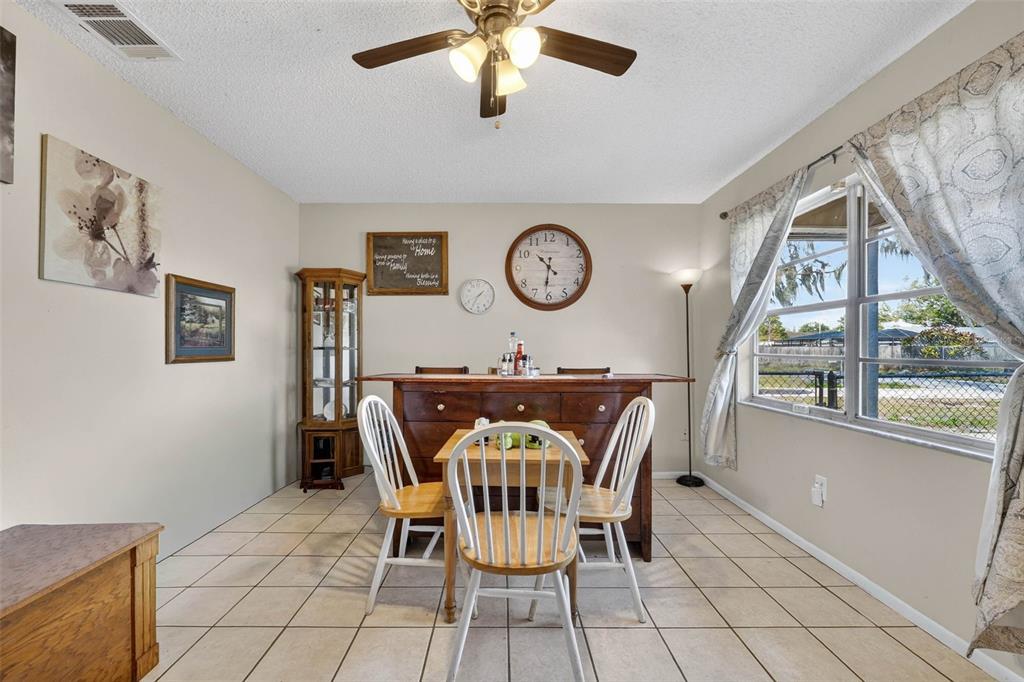 2613 Fowler Avenue Auburndale, FL 33823 - Photo 13 of 61 a view of a dining room with furniture and a large window