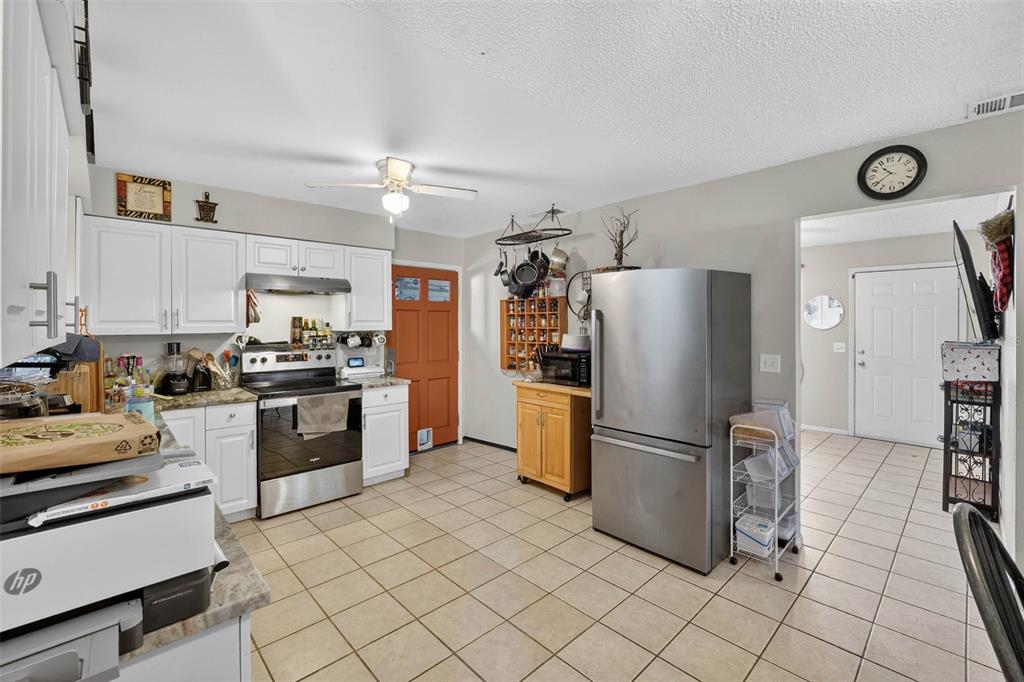 2613 Fowler Avenue Auburndale, FL 33823 - Photo 15 of 61 a kitchen with granite countertop a refrigerator a stove a sink and a refrigerator