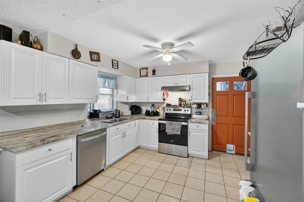 2613 Fowler Avenue Auburndale, FL 33823 - Photo 17 of 61 a kitchen with cabinets and stainless steel appliances