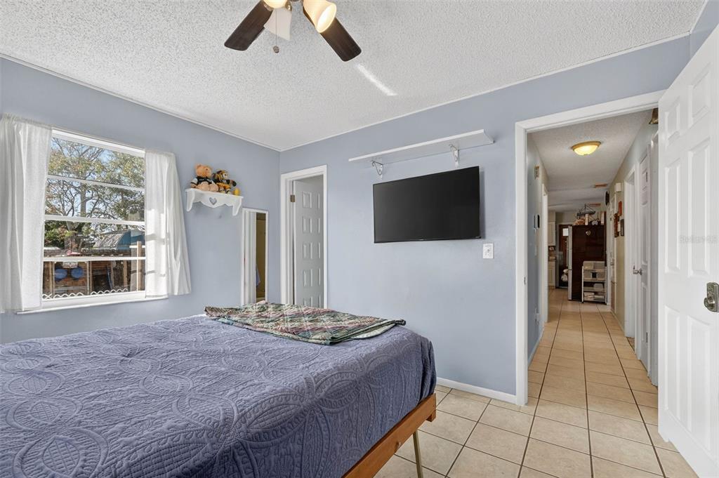 2613 Fowler Avenue Auburndale, FL 33823 - Photo 24 of 61 a bedroom with a bed and a flat screen tv