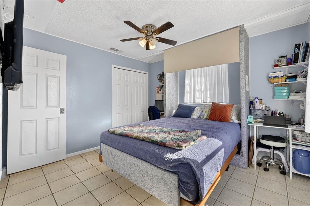 2613 Fowler Avenue Auburndale, FL 33823 - Photo 25 of 61 a bedroom with a bed and a chandelier