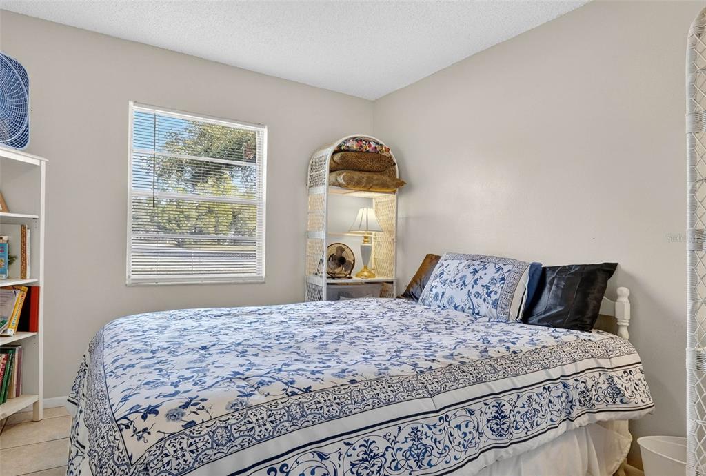 2613 Fowler Avenue Auburndale, FL 33823 - Photo 29 of 61 a bedroom with a bed and wooden floor