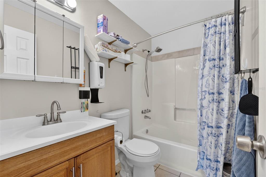 2613 Fowler Avenue Auburndale, FL 33823 - Photo 31 of 61 a bathroom with a sink toilet a mirror and shower