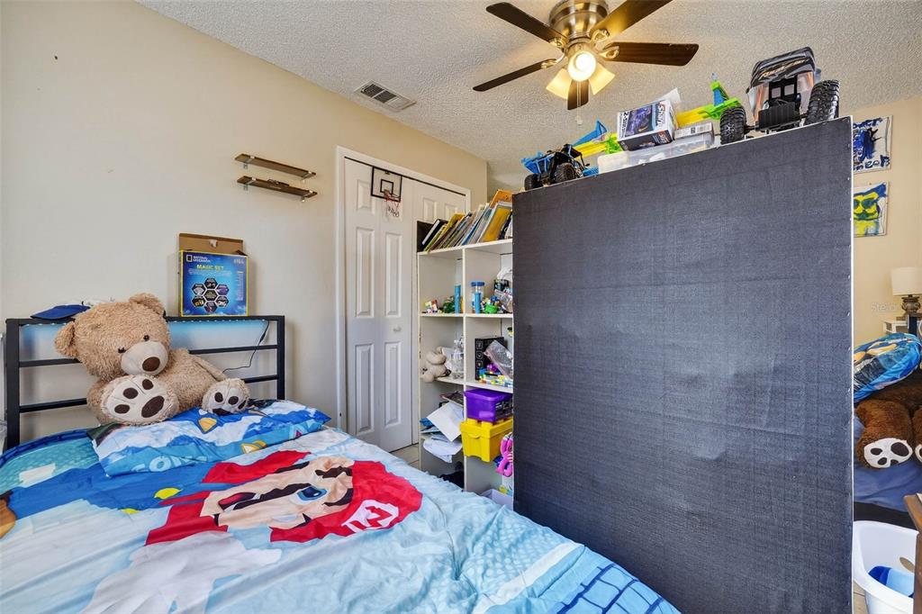 2613 Fowler Avenue Auburndale, FL 33823 - Photo 35 of 61 a bedroom with a bed and a chandelier