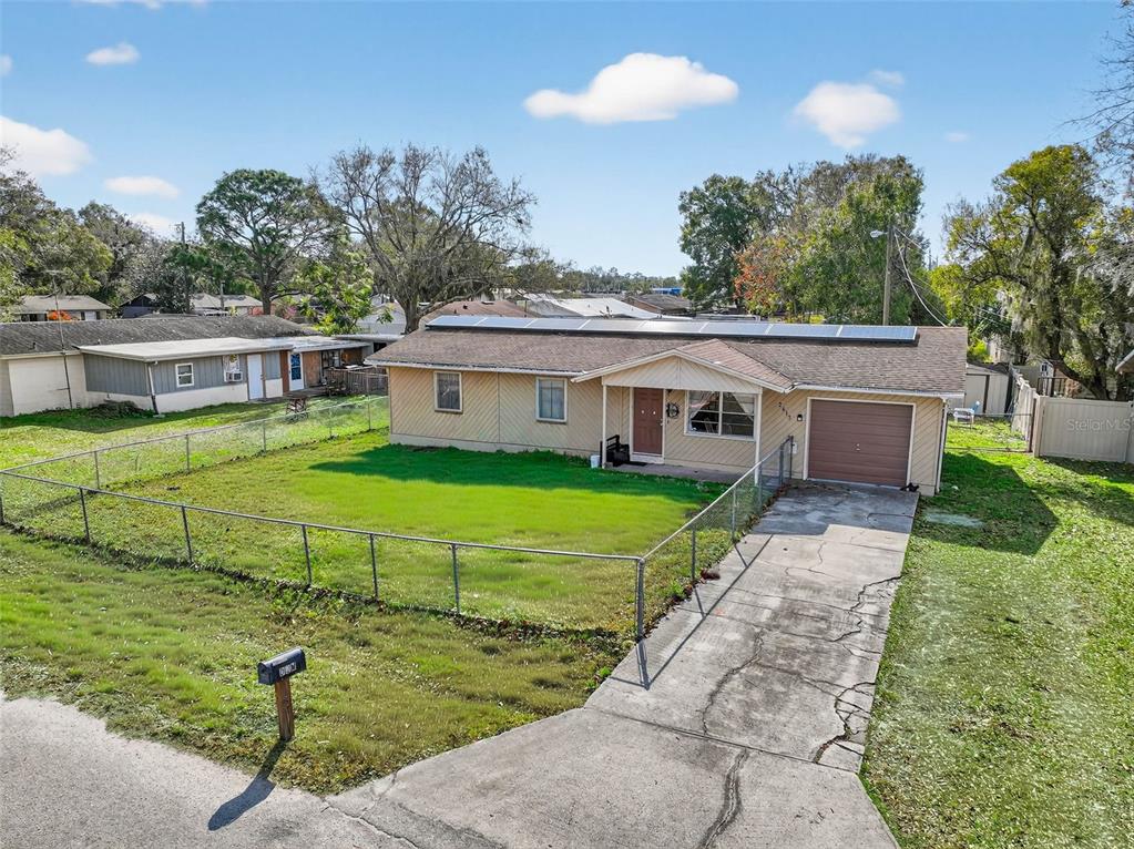 2613 Fowler Avenue Auburndale, FL 33823 - Photo 4 of 61 a view of a white house with a big yard plants and large trees