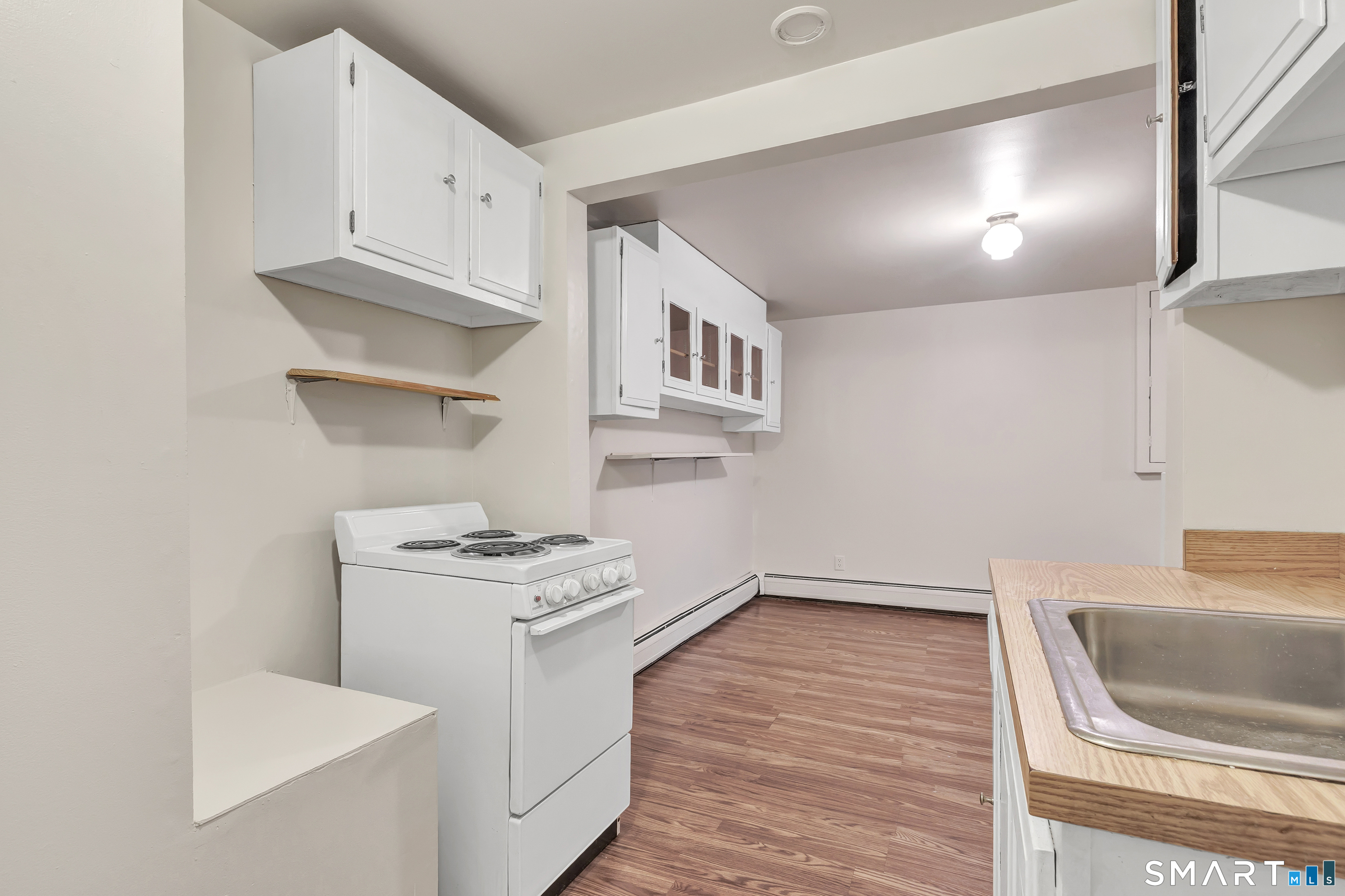 123 River Road Shelton, CT 06484 - Photo 23 of 27 a kitchen with white cabinets and appliances