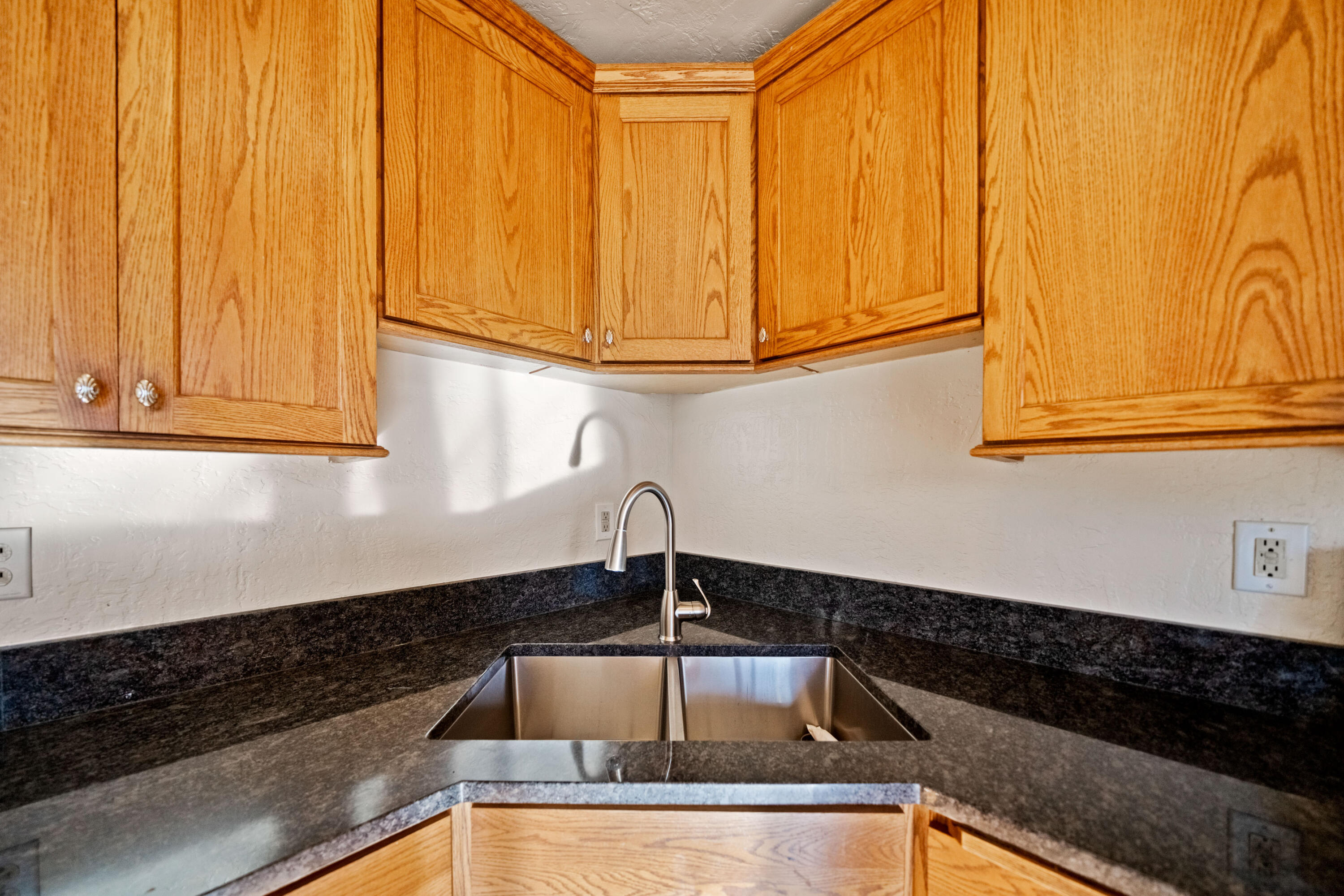 12161 Randolph Road Redding, CA 96003 - Photo 13 of 37 a kitchen with granite countertop a sink and cabinets