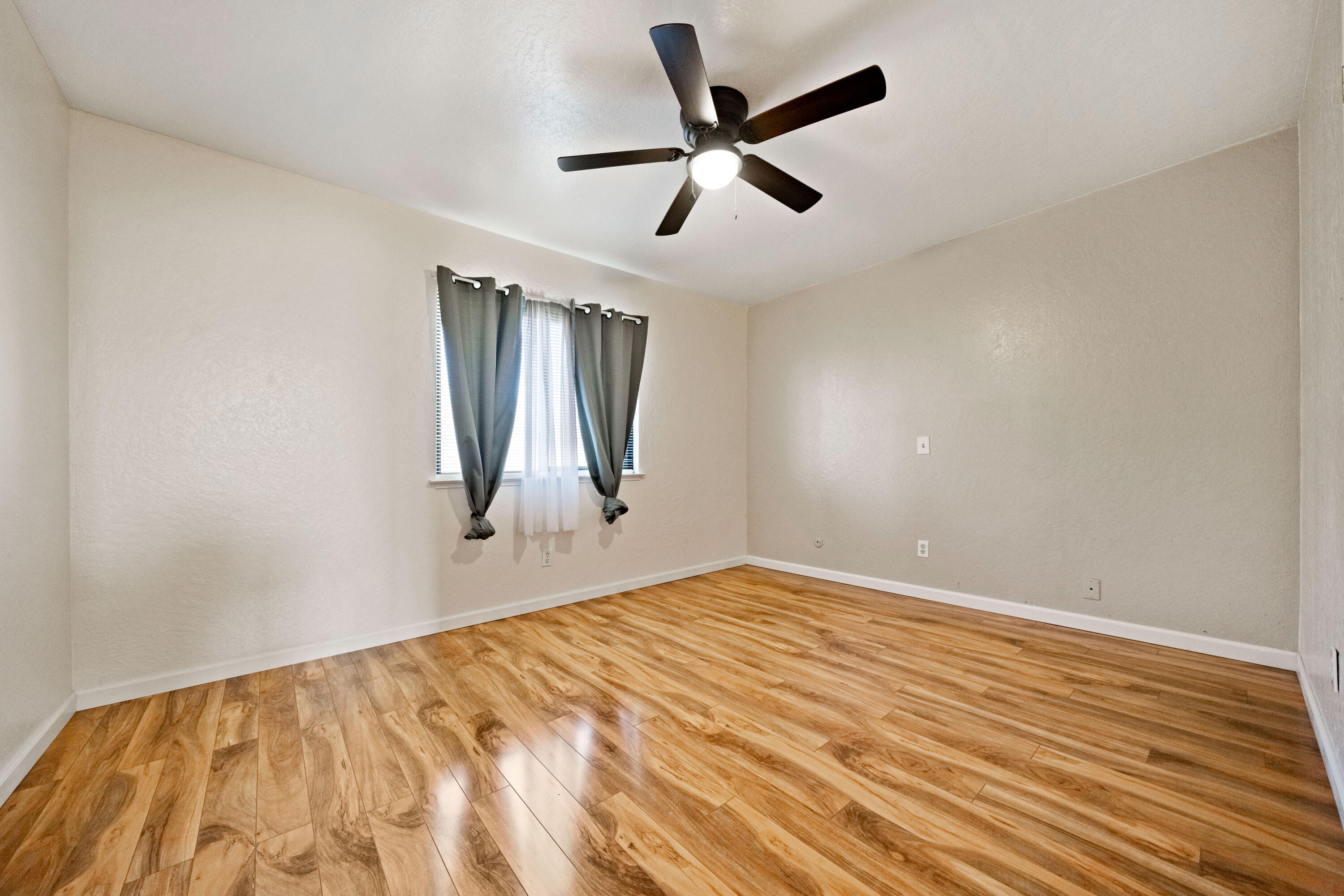 12161 Randolph Road Redding, CA 96003 - Photo 17 of 37 a view of empty room with wooden floor and fan