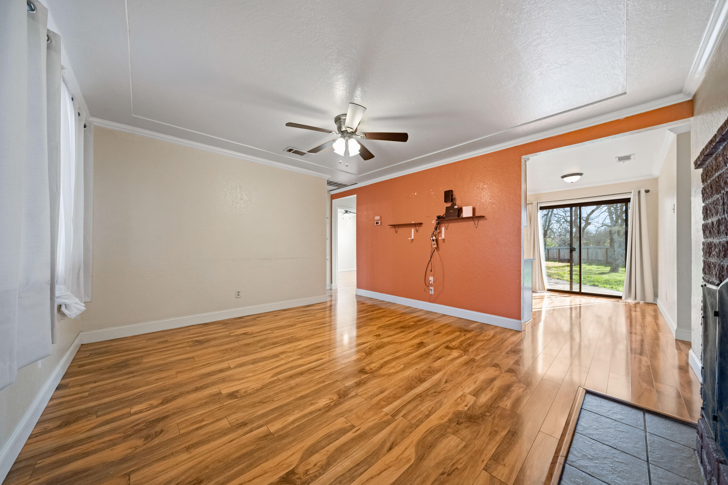 12161 Randolph Road Redding, CA 96003 - Photo 7 of 37 a view of an empty room with wooden floor and a window