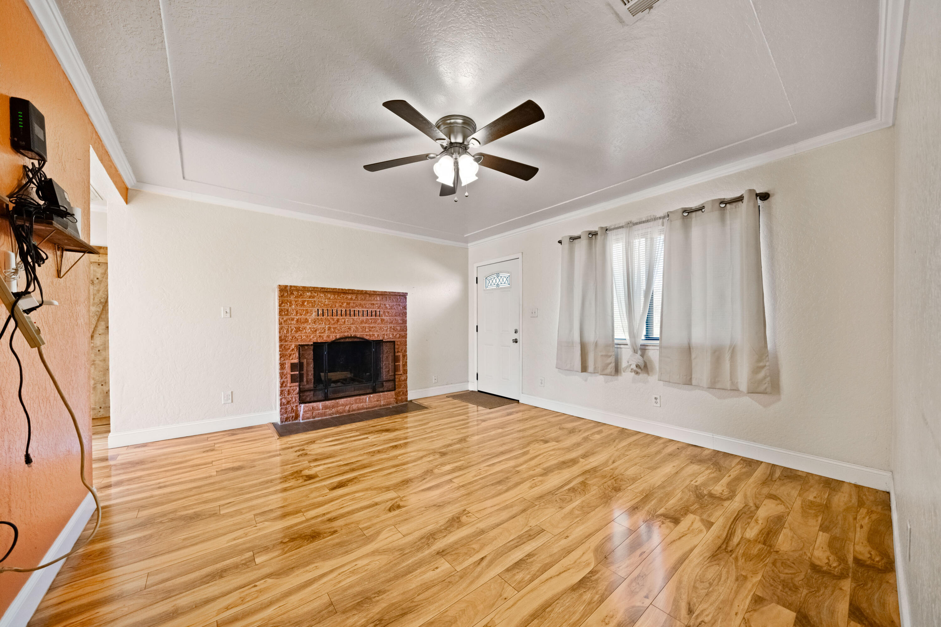 12161 Randolph Road Redding, CA 96003 - Photo 8 of 37 a view of an empty room with a fireplace and a window