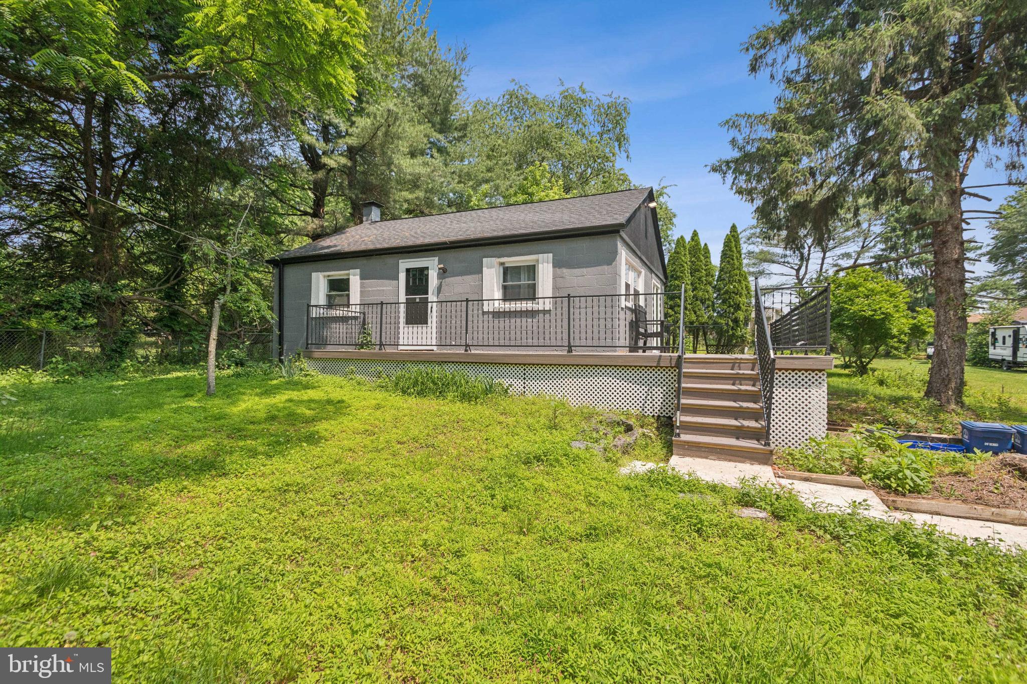 a view of a house with yard and sitting area