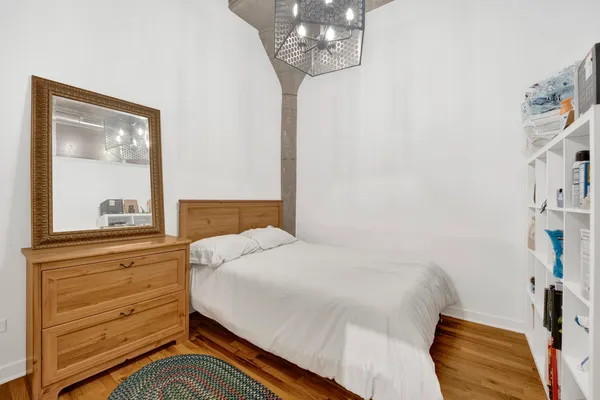 a bedroom with a bed and a mirror