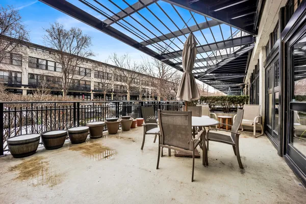 a view of a patio with table and chairs and potted plants