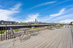 a view of a balcony with wooden floor and city view