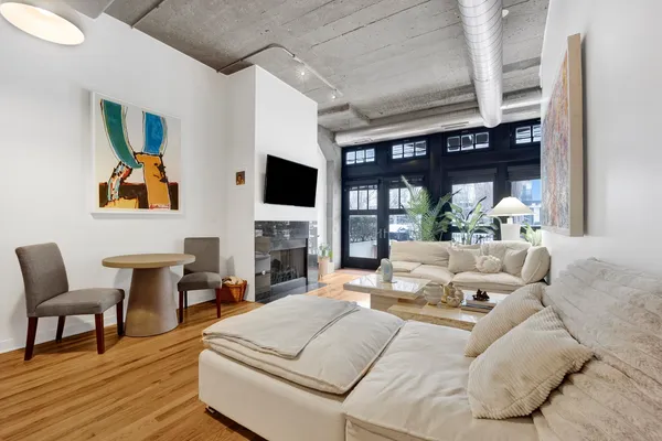 a living room with furniture a fireplace and a flat screen tv
