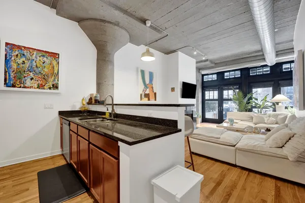 a kitchen with stainless steel appliances granite countertop a sink and a white cabinets