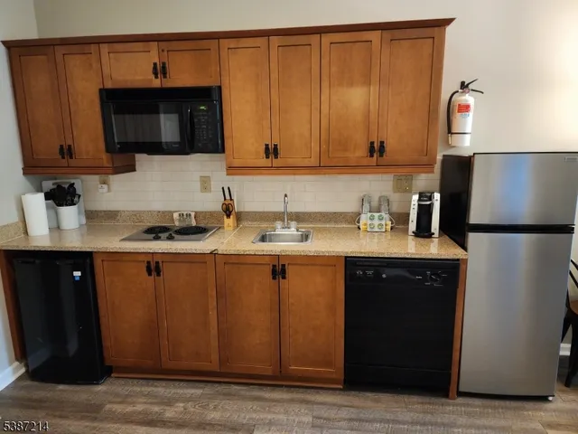 a kitchen with stainless steel appliances granite countertop a sink stove and microwave