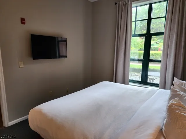a bed sitting in a bedroom next to a window