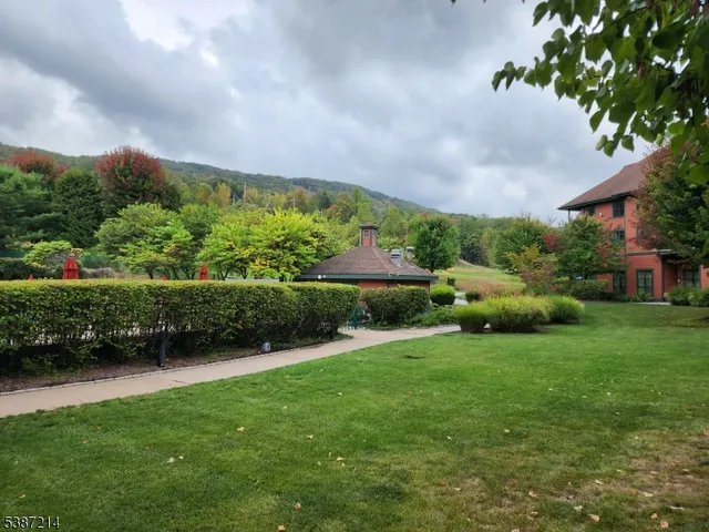 a view of a garden with a building in the background