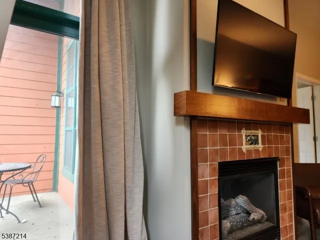 a living room with a fireplace and a flat screen tv