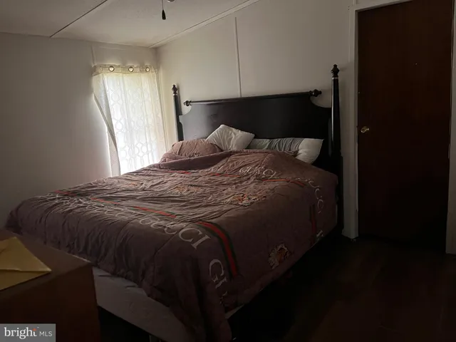 a bed sitting in a bedroom next to a window