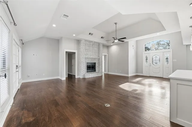 wooden floor in an empty room with a fireplace