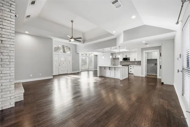 a view of a kitchen with wooden floor and a kitchen
