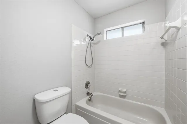 a bathroom with a toilet and shower