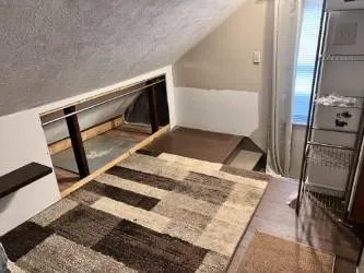 a bedroom with a bed and a mirror on the dresser