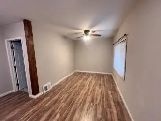 wooden floor in an empty room with a mirror