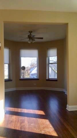 5708 South Aberdeen Street Chicago, IL 60621 - Photo 17 of 25 a view of empty room with wooden floor and fan