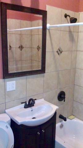 5708 South Aberdeen Street Chicago, IL 60621 - Photo 20 of 25 a bathroom with a sink and a mirror