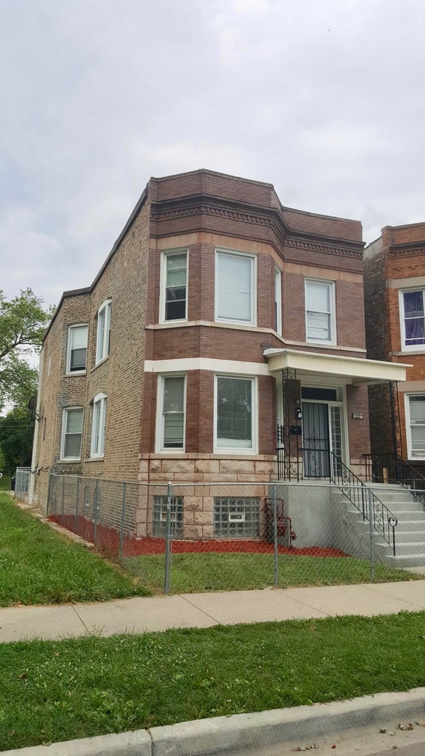5708 South Aberdeen Street Chicago, IL 60621 - Photo 3 of 25 a front view of a house with a yard