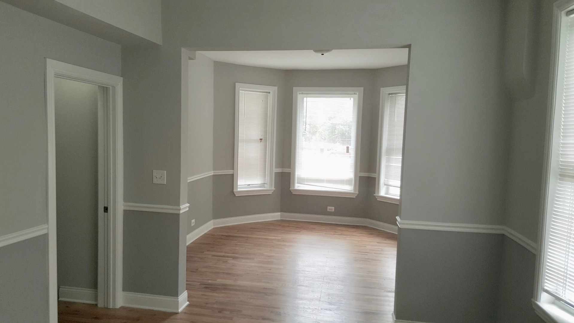 5708 South Aberdeen Street Chicago, IL 60621 - Photo 4 of 25 a view of empty room with wooden floor and fan