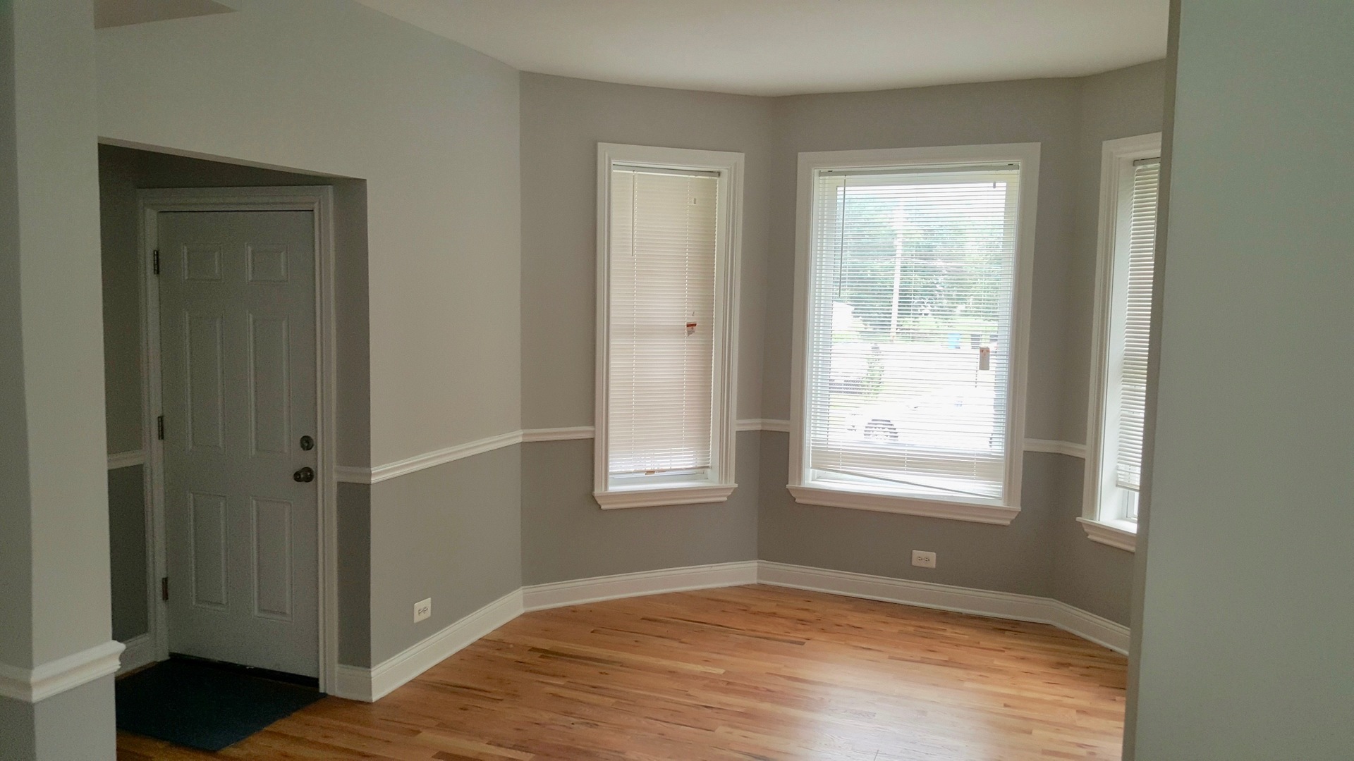 5708 South Aberdeen Street Chicago, IL 60621 - Photo 5 of 25 a view of an empty room with wooden floor and a window